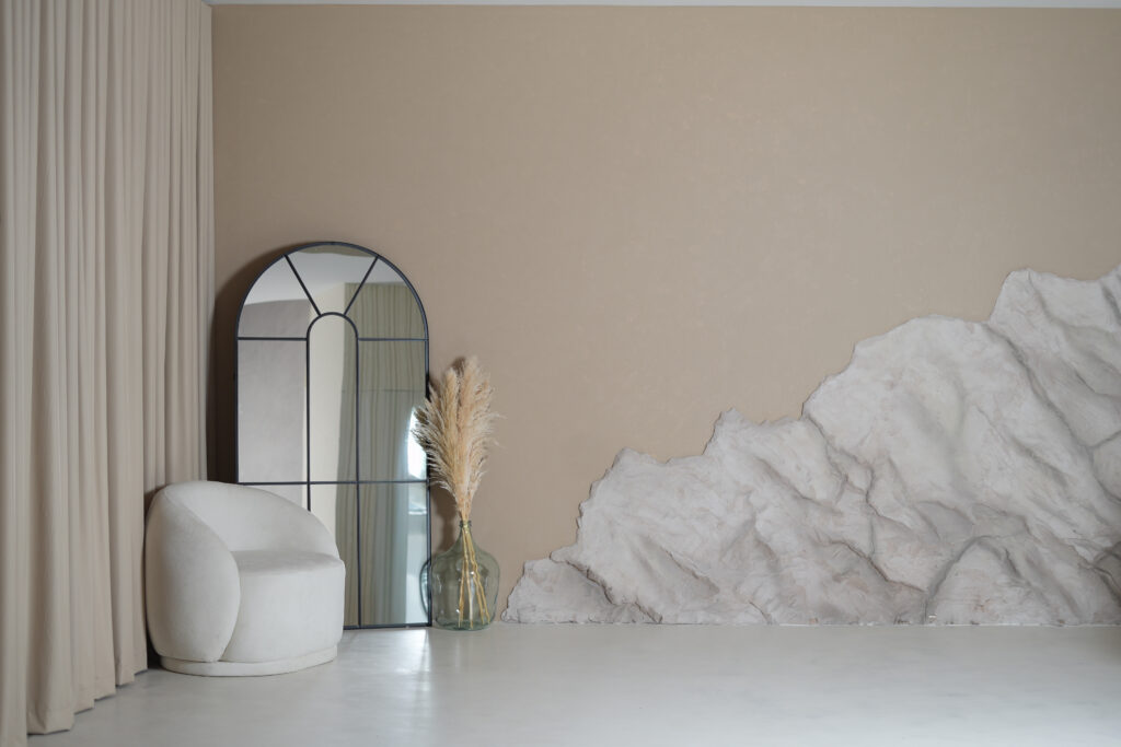 Artio styled studio corner with mirror, seating and textured wall