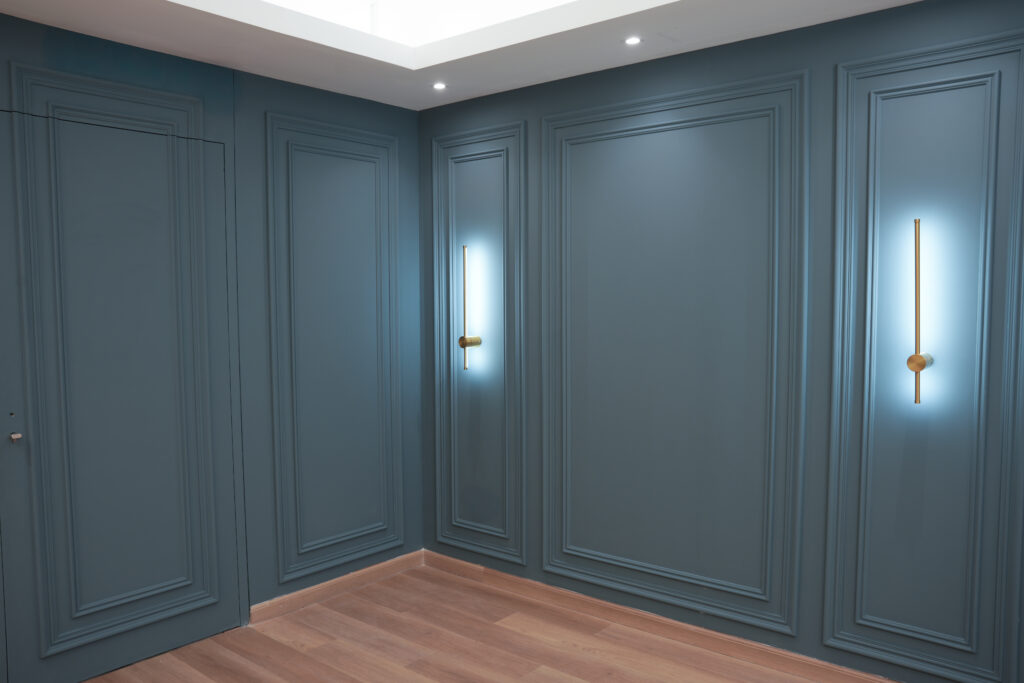 Blue studio wall with warm accent lighting